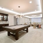 Beautiful basement entertaining room with LED lighting in tray ceiling