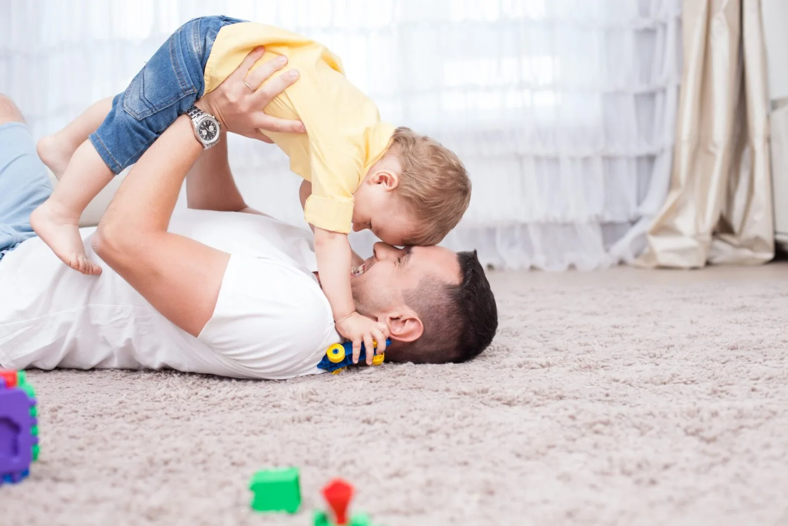 Father and child on clean carpet
